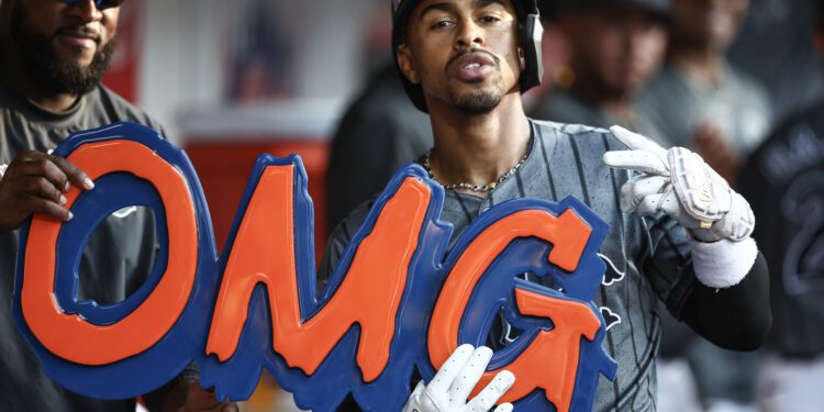 Jul 13, 2024; New York City, New York, USA; New York Mets shortstop Francisco Lindor (12) celebrates in the dugout after hitting a three run home run in the eighth inning against the Colorado Rockies at Citi Field. Mandatory Credit: Wendell Cruz-USA TODAY Sports