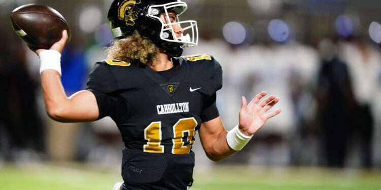 Oct 20, 2023; Carrollton, GA, USA; Carrollton Trojans quarterback Julian Lewis (10) drops back to pass against the Westlake Lions during the first half at Grisham Stadium. The 15-year-old Carrollton High student has already committed to playing for the University of Southern California Trojans and has been considered one of the top high school quarterback prospects. Mandatory Credit: John David Mercer-USA TODAY Sports