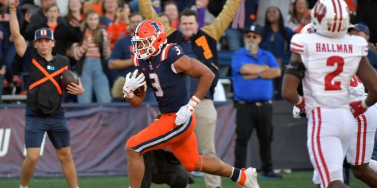 Oct 21, 2023; Champaign, Illinois, USA; Illinois Fighting Illini running back Kaden Feagin (3) scores a touchdown during the second half against the Wisconsin Badgers at Memorial Stadium. Mandatory Credit: Ron Johnson-USA TODAY Sports