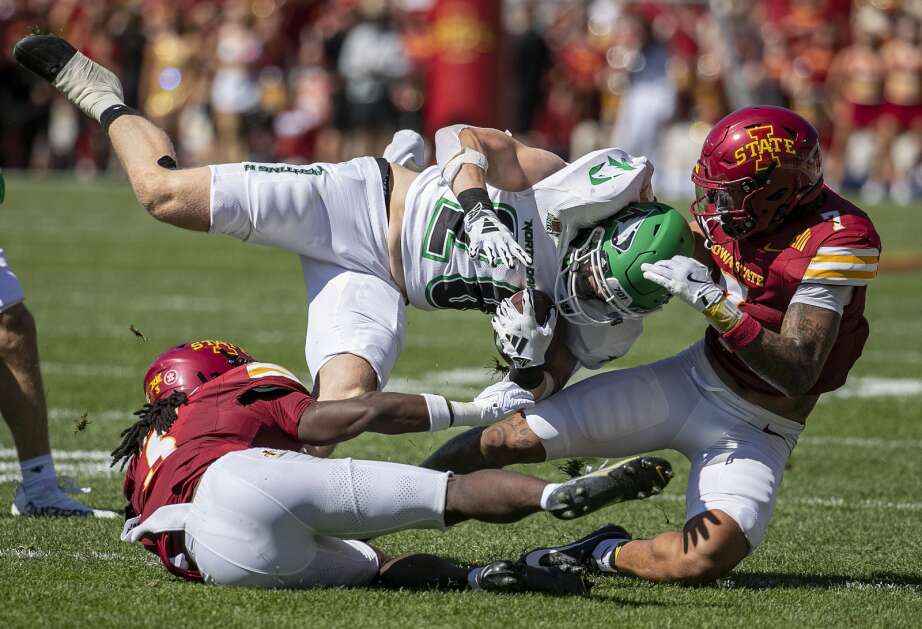 Iowa State Cyclones defensive back Malik Verdon (7) and Iowa State Cyclones defensive back Jontez Williams (3) pull down North Dakota Fighting Hawks running back Gaven Ziebarth (28) as he carries the ball in the first quarter at Jack Trice Stadium in Ames, Iowa on Saturday, Aug. 31, 2024. (Savannah Blake/The Gazette)