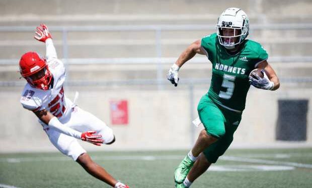 Lincoln's Ty Olsen, right, runs the ball against Las Vegas Arbor View's Izaiah Lekuti during their game at Southwestern College on Saturday, Aug. 24, 2024 in Chula Vista, CA. (Meg McLaughlin / The San Diego Union-Tribune)