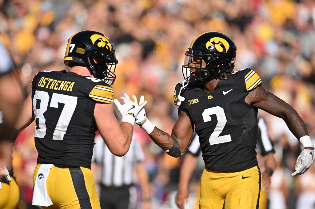 Iowa Hawkeyes tight end Addison Ostrenga (87) and running back Kaleb Johnson (2) react after a touchdown by Johnson during the third quarter against the Iowa State Cyclones at Kinnick Stadium.