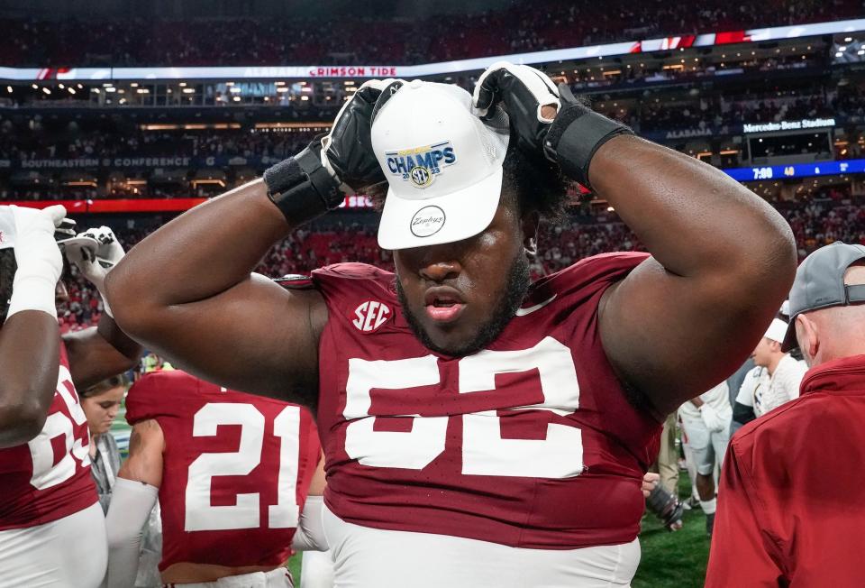 Dec 2, 2023; Atlanta, GA, USA; Alabama Crimson Tide offensive lineman Tyler Booker (52) dons an SEC Championship cap at Mercedes-Benz Stadium. Alabama defeated Georgia 27-24 to claim the SEC Championship. Mandatory Credit: Gary Cosby Jr.-USA TODAY Sports