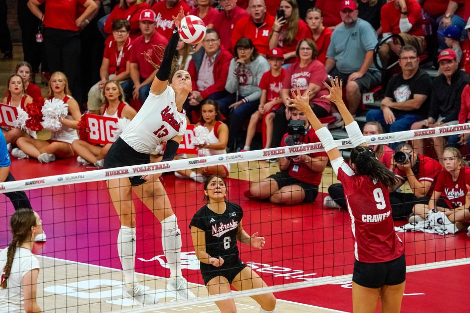 Oct 21, 2023; Lincoln, NE, USA; Nebraska Cornhuskers outside hitter Merritt Beason (13) attacks against Wisconsin Badgers middle blocker Caroline Crawford (9) during the fifth set at the Bob Devaney Sports Center. Mandatory Credit: Dylan Widger-USA TODAY Sports