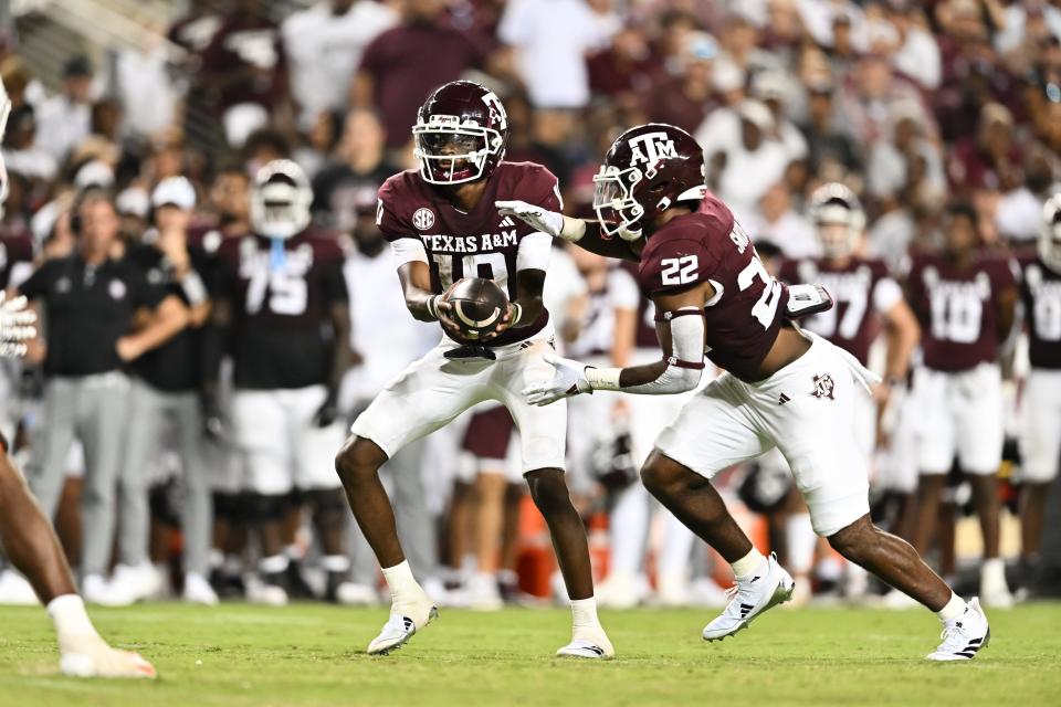 Sep 21, 2024; College Station, Texas, USA; Texas A&M Aggies quarterback Marcel Reed (10) hands off the ball to running back EJ Smith (22) during the fourth quarter at Kyle Field. Mandatory Credit: Maria Lysaker-Imagn Images.