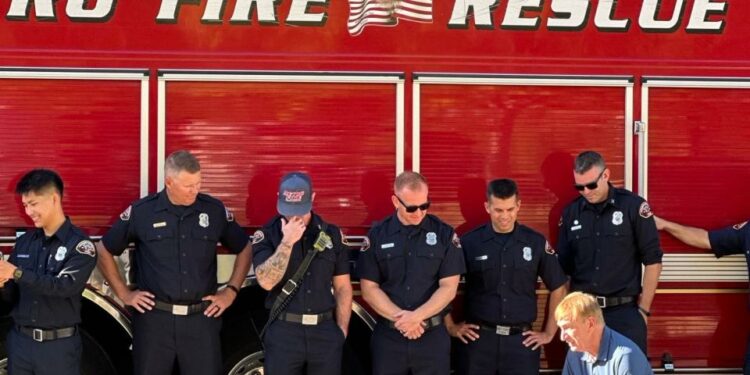 Maya with the firefighters who helped save her and her family.