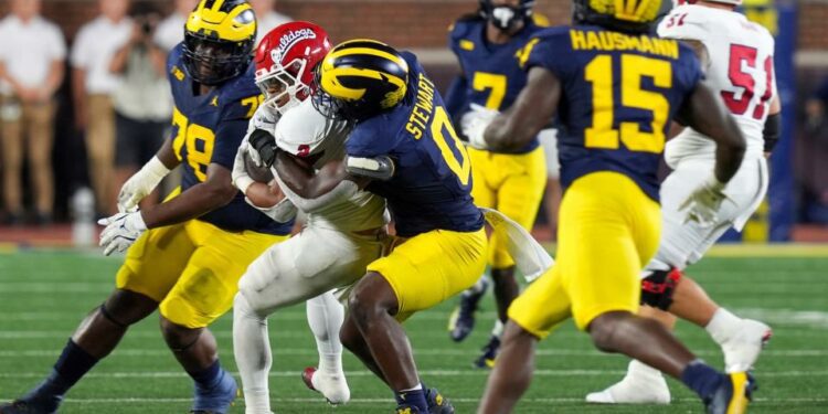 Michigan edge rusher Josaiah Stewart (0) tackles Fresno State running back Malik Sherrod (2) during the second half at Michigan Stadium in Ann Arbor on Saturday, Aug. 31, 2024.