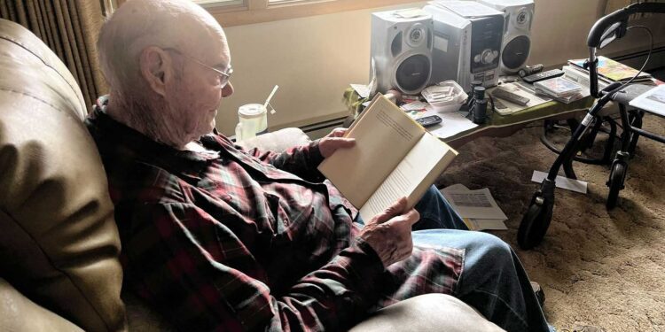 Robert Boettcher reads from his home in Big Sandy.