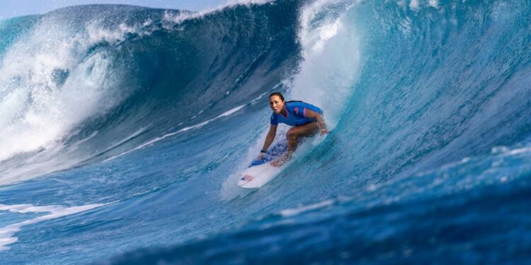 Carissa Moore rides a wave during the surfing quarterfinals in Teahupo'o, French Polynesia.