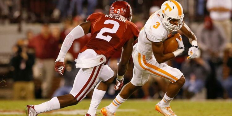 Sep 13, 2014; Norman, OK; Tennessee Volunteers wide receiver Josh Malone (3) runs with the ball as Oklahoma Sooners cornerback Julian Wilson (2) chases during the first half at Gaylord Family - Oklahoma Memorial Stadium. Mandatory Credit: Kevin Jairaj-USA TODAY Sports