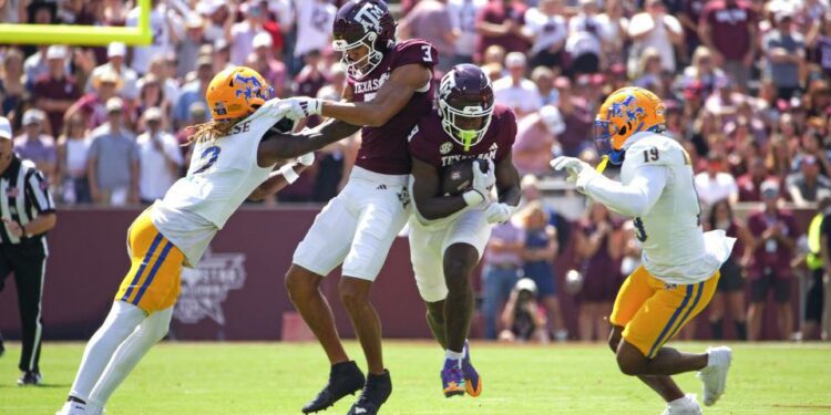 Sep 7, 2024; College Station, Texas, USA; Texas A&M Aggies running back Le'Veon Moss (8) runs the ball while wide receiver Noah Thomas (3) blocks McNeese State Cowboys defensive back Levi Wyatt (2) during the first quarter at Kyle Field. Mandatory Credit: Dustin Safranek-Imagn Images