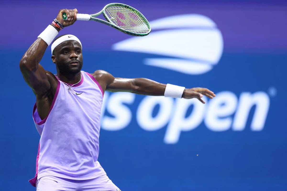 Frances Tiafoe of the United States returns a shot against Alexei Popyrin of Australia during their Men's Singles Fourth Round match on Day Seven of the 2024 US Open at USTA Billie Jean King National Tennis Center