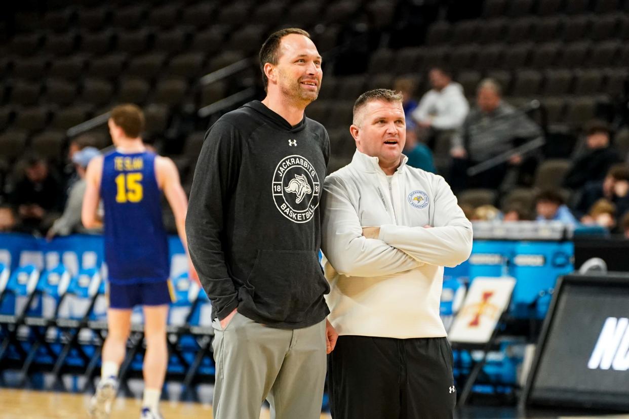 Mar 20, 2024; Omaha, NE, USA; South Dakota State Jackrabbits head coach Eric Henderson and assistant coach Rob Klinkefus watch warmups during the NCAA first round practice session at CHI Health Center Omaha. Mandatory Credit: Dylan Widger-USA TODAY Sports