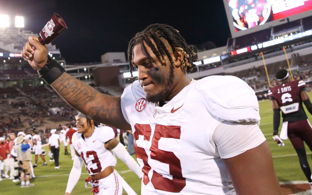 Sep 30, 2023; Starkville, Mississippi, USA; Alabama Crimson Tide offensive lineman JC Latham (65) celebrates with a cow bell in Davis Wade Stadium at Mississippi State University. Alabama defeated Mississippi State 40-17. Mandatory Credit: Gary Cosby Jr.-Tuscaloosa News