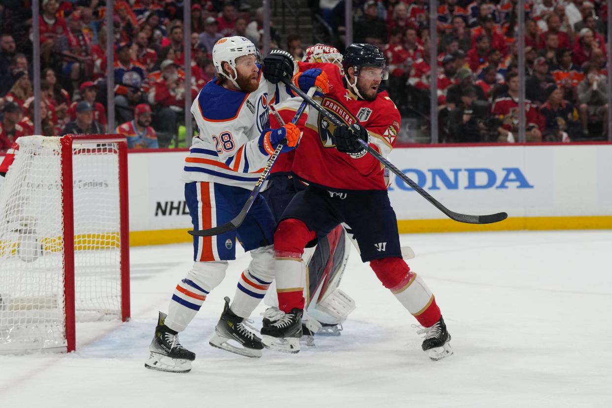 Jun 10, 2024; Sunrise, Florida, USA; Florida Panthers defenseman Dmitry Kulikov (7) defends against Edmonton Oilers forward Connor Brown (28) during the third period in game two of the 2024 Stanley Cup Final at Amerant Bank Arena. Mandatory Credit: Jim Rassol-USA TODAY Sports