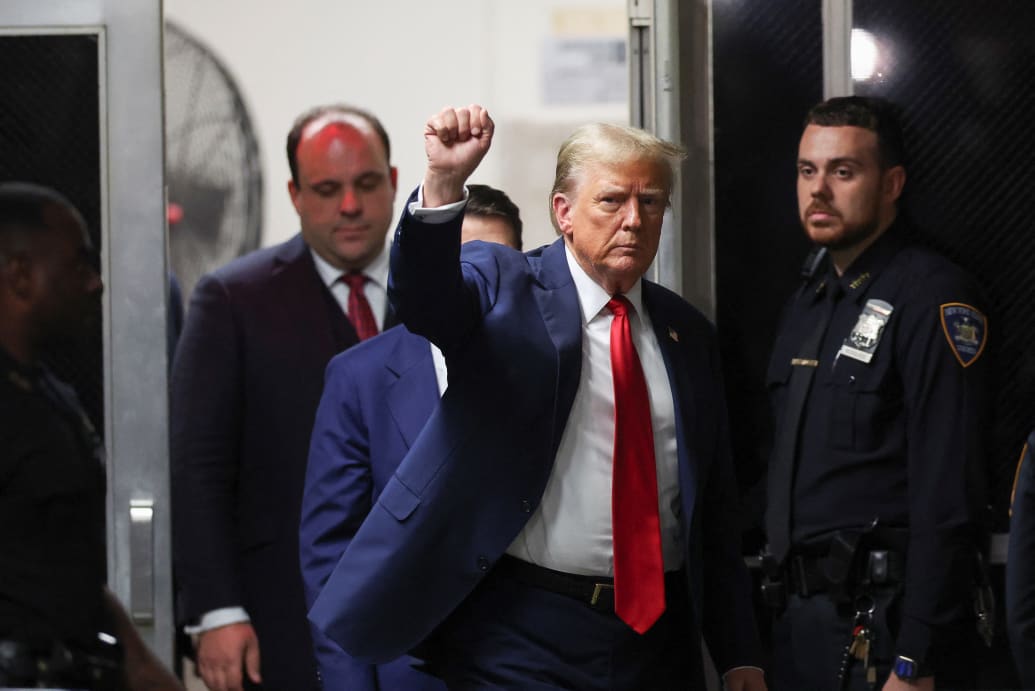 Boris Epshteyn exits a New York courthouse behind Donald Trump after a hearing in the former president’s hush-money trial.