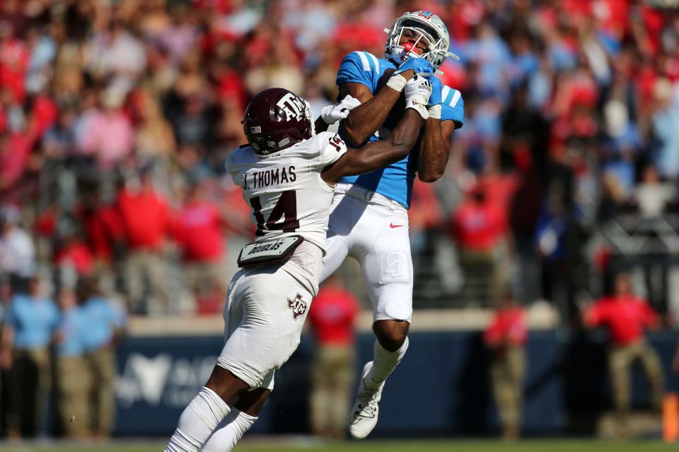 Nov 4, 2023; Oxford, Mississippi, USA; Mississippi Rebels wide receiver Tre Harris (9) catches the ball against Texas A&M Aggies defensive back Jayvon Thomas (14) during the first half at Vaught-Hemingway Stadium. Mandatory Credit: Petre Thomas-USA TODAY Sports