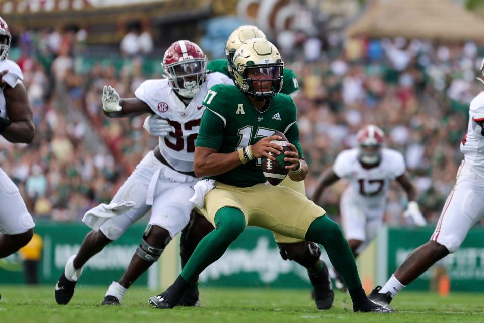 Sep 16, 2023; Tampa, Florida, USA; South Florida Bulls quarterback Byrum Brown (17) is pressured by Alabama Crimson Tide linebacker Deontae Lawson (32) in the first quarter at Raymond James Stadium. Mandatory Credit: Nathan Ray Seebeck-USA TODAY Sports