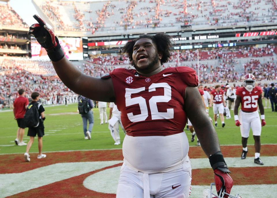 Sep 23, 2023; Tuscaloosa, Alabama, USA; Alabama Crimson Tide offensive lineman Tyler Booker (52) celebrates as he leaves the field at Bryant-Denny Stadium. Alabama defeated Mississippi 24-10. Mandatory Credit: Gary Cosby Jr.-USA TODAY Sports