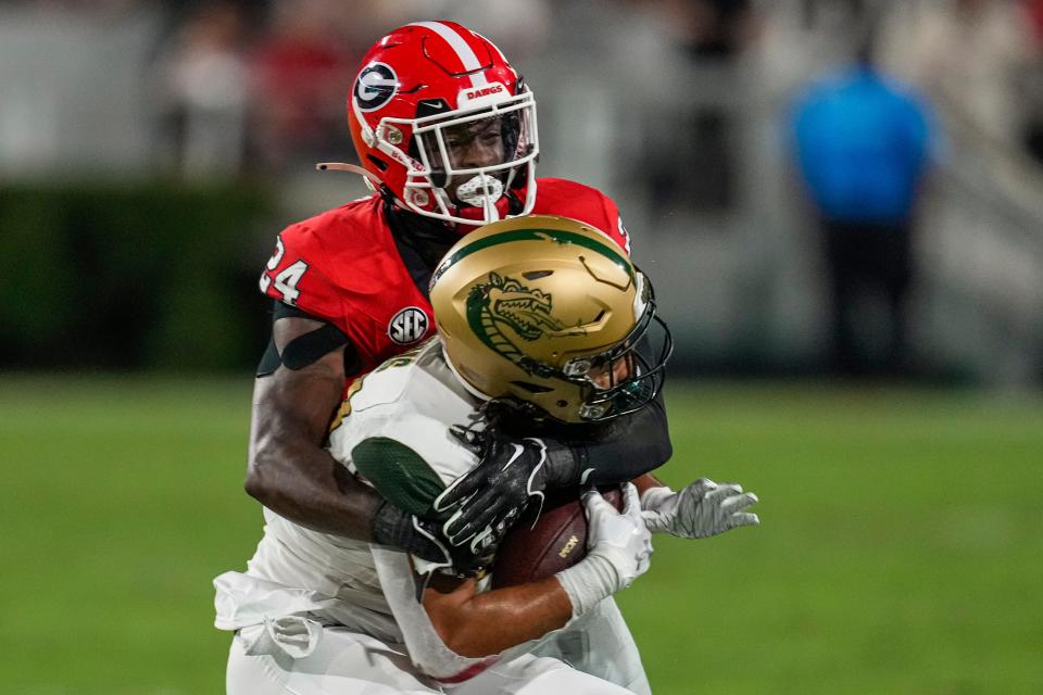 Sep 23, 2023; Athens, Georgia, USA; Georgia Bulldogs defensive back Malaki Starks (24) tackles a UAB Blazers runner at Sanford Stadium. Mandatory Credit: Dale Zanine-USA TODAY Sports