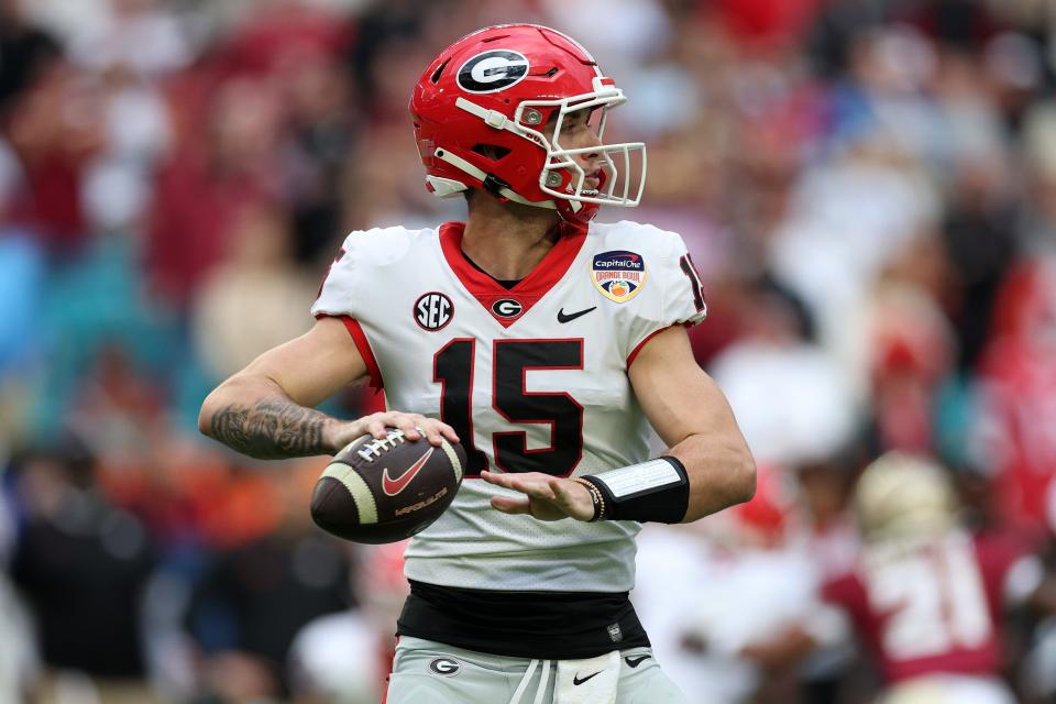 Dec 30, 2023; Miami Gardens, FL, USA; Georgia Bulldogs quarterback Carson Beck (15) drops back to pass against the Florida State Seminoles during the first half in the 2023 Orange Bowl at Hard Rock Stadium. Mandatory Credit: Nathan Ray Seebeck-USA TODAY Sports