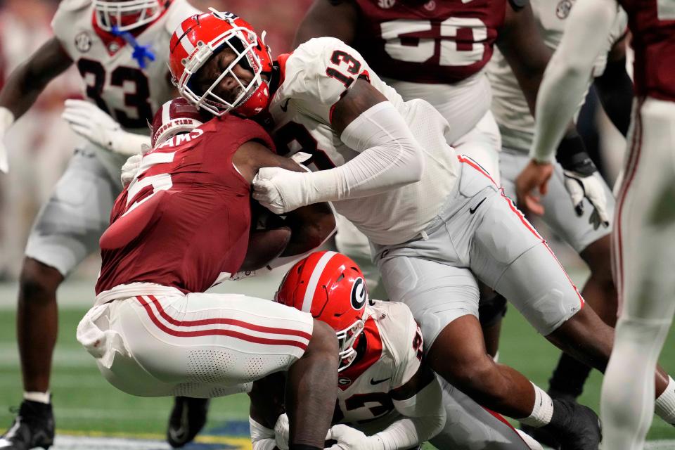 Dec 2, 2023; Atlanta, GA, USA; Georgia Bulldogs defensive lineman Mykel Williams (13) tackles Alabama Crimson Tide running back Roydell Williams (5) during the second half in the SEC Championship game at Mercedes-Benz Stadium. Mandatory Credit: Dale Zanine-USA TODAY Sports