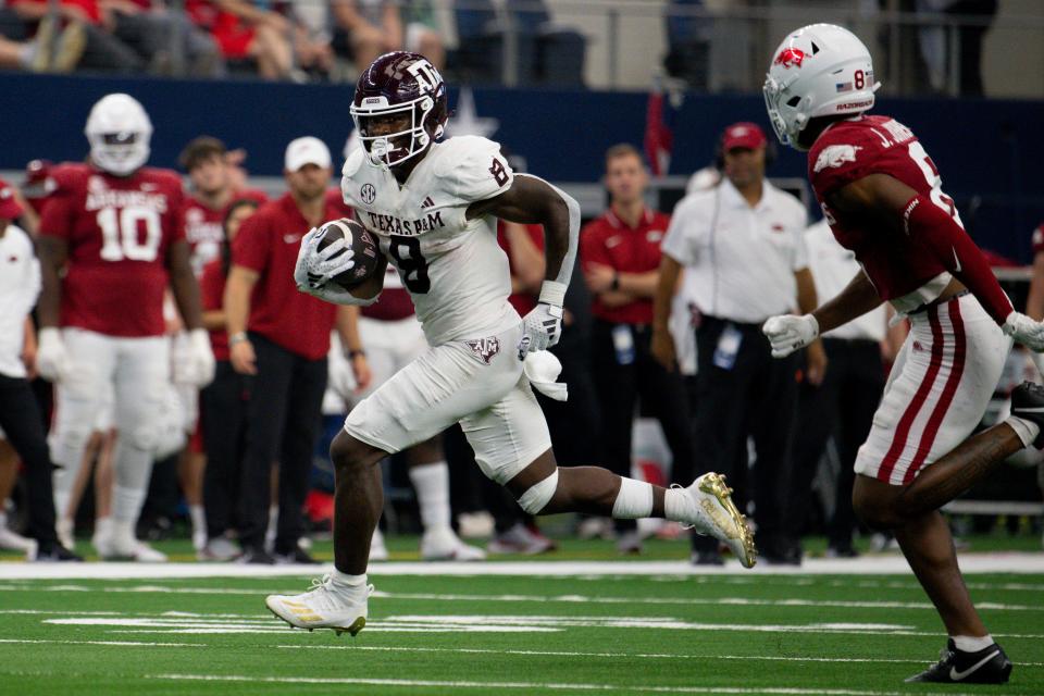 Sep 30, 2023; Arlington, Texas, USA; Texas A&M Aggies running back Le'Veon Moss (8) runs for a first down against the Arkansas Razorbacks during the second half at AT&T Stadium. Mandatory Credit: Jerome Miron-USA TODAY Sports