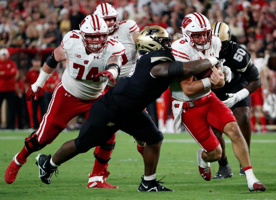 Purdue Boilermakers linebacker Nic Scourton (5) tackles Wisconsin Badgers quarterback Tanner Mordecai (8) during the NCAA football game, Friday, Sept. 22, 2023, at Ross-Ade Stadium in West Lafayette, Ind. Wisconsin Badgers won 38-17.