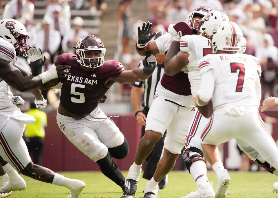 Oct 28, 2023; College Station, Texas; Texas A&M Aggies defensive lineman Shemar Turner (5) rushes South Carolina Gamecocks quarterback Spencer Rattler (7) during the second half at Kyle Field. Dustin Safranek-USA TODAY Sports