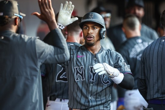 Jul 13, 2024; New York City, New York, USA; New York Mets shortstop Francisco Lindor (12) is greeted in the dugout after hitting a three run home run in the eighth inning against the Colorado Rockies at Citi Field. Mandatory Credit: Wendell Cruz-USA TODAY Sports