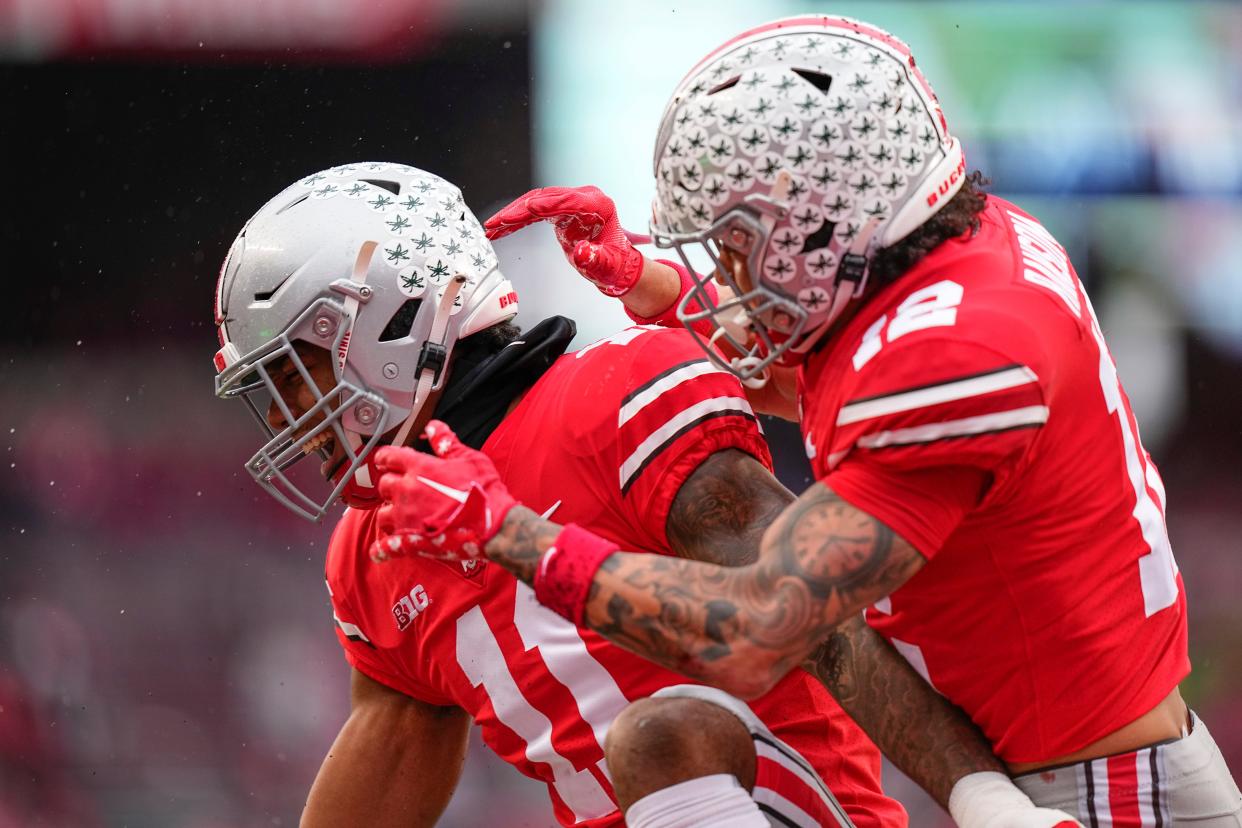 Nov 12, 2022; Columbus, Ohio, USA;  Ohio State Buckeyes safety Lathan Ransom (12) celebrates a tackle by linebacker C.J. Hicks (11) during the second half of the NCAA football game against the Indiana Hoosiers at Ohio Stadium. Ohio State won 56-14. Mandatory Credit: Adam Cairns-The Columbus Dispatch