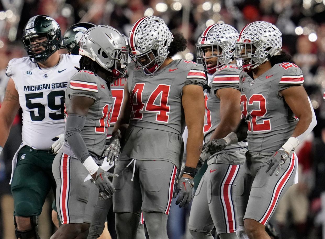 Nov 11, 2023; Columbus, Ohio, USA; Ohio State Buckeyes defensive end JT Tuimoloau (44) and Ohio State Buckeyes linebacker C.J. Hicks (11) celebrate a tackle during the NCAA football game against Michigan State University at Ohio Stadium.