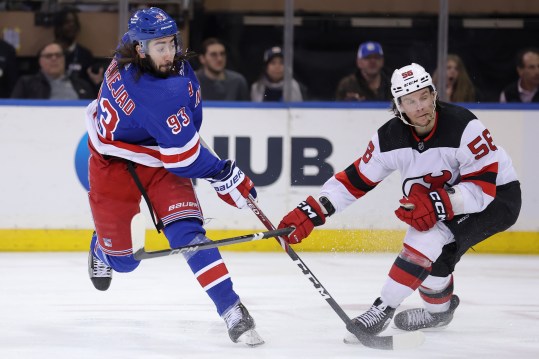 New York Rangers center Mika Zibanejad (93) follows through on a shot against New Jersey Devils left wing Erik Haula (56) during the third period at Madison Square Garden