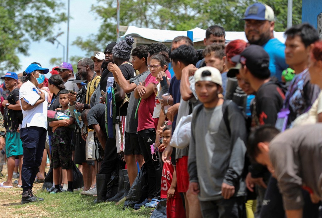 Migrants queue for a medical check at the Migrants Reception Station during a visit by Panama's President-elect Jose Raul Mulino (not pictured), in Lajas Blancas, Darien province, Panama, June 28, 2024. 