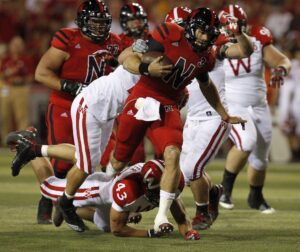 Nebraska Cornhuskers quarterback Taylor Martinez (3) runs over Wisconsin Badgers defender Michael Trotter (43) at Memorial Stadium in the first half.