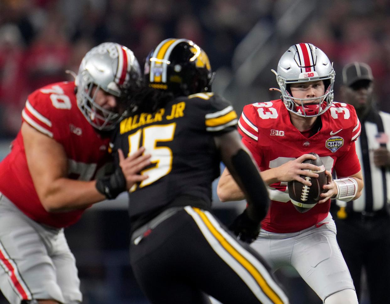 Dec 29, 2023; Arlington, Texas, USA; Ohio State Buckeyes quarterback Devin Brown (33) drops back against Missouri Tigers defense in the first quarter during the Goodyear Cotton Bowl Classic at AT&T Stadium.