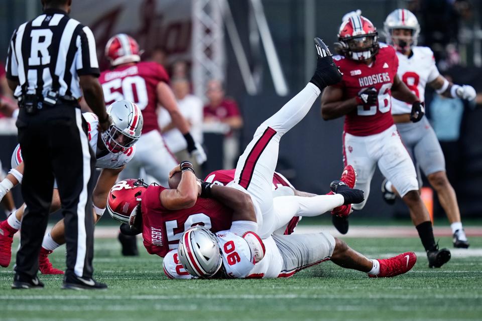 Sep 2, 2023; Bloomington, Indiana, USA; Ohio State Buckeyes defensive tackle Jaden McKenzie (90) tackles Indiana Hoosiers quarterback Brendan Sorsby (15) during the second half of the NCAA football game at Indiana University Memorial Stadium. Ohio State won 23-3.