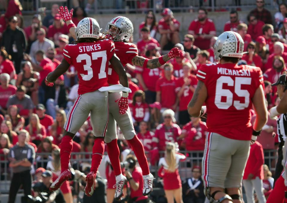 Oct 22, 2022; Columbus, Ohio, USA;  Ohio State Buckeyes safety Kye Stokes (37) and Ohio State Buckeyes wide receiver Caleb Burton (12) celebrate a touchdown in their NCAA Division I football game between the Ohio State Buckeyes and the Iowa Hawkeyes at Ohio Stadium. Mandatory Credit: Brooke LaValley/Columbus Dispatch