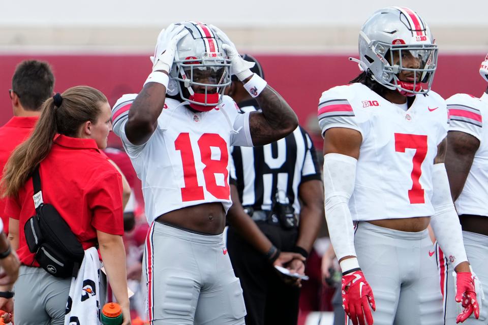 Sep 2, 2023; Bloomington, Indiana, USA; Ohio State Buckeyes cornerback Jyaire Brown (18) and cornerback Jordan Hancock (7) warm up prior to the NCAA football game at Indiana University Memorial Stadium. Ohio State won 23-3.