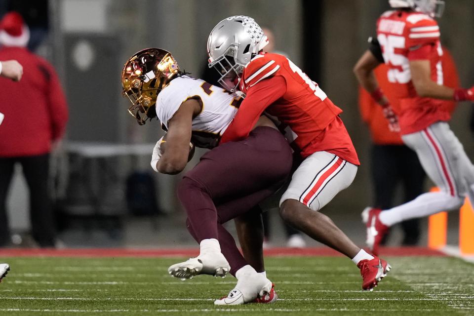 Nov 18, 2023; Columbus, Ohio, USA; Ohio State Buckeyes cornerback Ryan Turner (12) tackles Minnesota Golden Gophers running back Jordan Nubin (30) during the NCAA football game against the Minnesota Golden Gophers at Ohio Stadium.