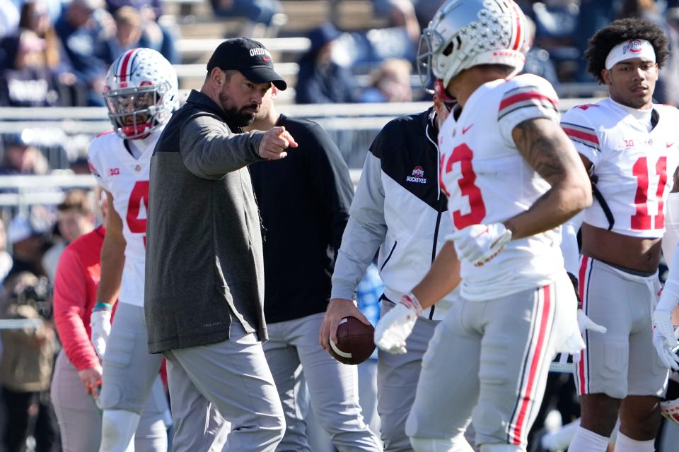 Oct 29, 2022; University Park, Pennsylvania, USA; Ohio State Buckeyes head coach Ryan Day points to safety Cameron Martinez (13) prior to the NCAA Division I football game against the Penn State Nittany Lions at Beaver Stadium. Mandatory Credit: Adam Cairns-The Columbus Dispatch