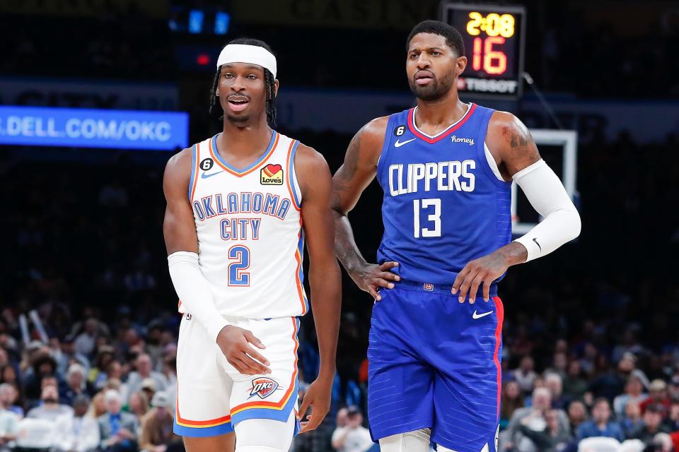 Oct 27, 2022; Oklahoma City, Oklahoma, USA; Oklahoma City Thunder guard Shai Gilgeous-Alexander (2) and LA Clippers guard Paul George (13) walks down the court during a time out during the first half at Paycom Center. Mandatory Credit: Alonzo Adams-USA TODAY Sports