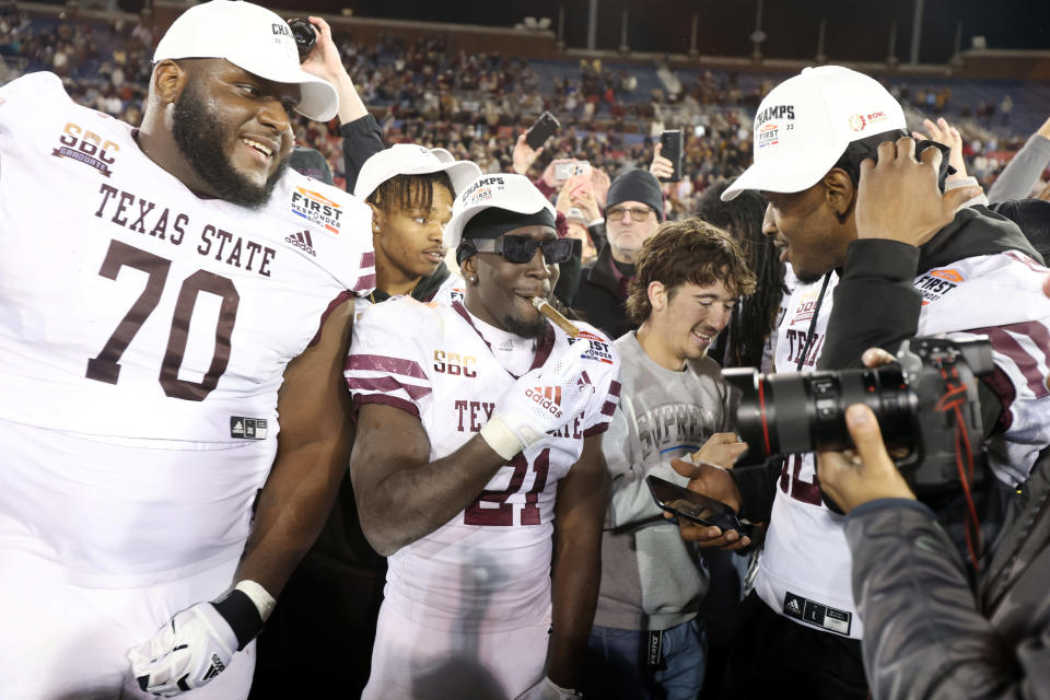 Dec 26, 2023; Dallas, TX, USA; Texas State Bobcats running back Ismail Mahdi (21) and offensive lineman Brey Walker (70) celebrate after the game against the Rice Owls at Gerald J Ford Stadium. Mandatory Credit: Tim Heitman-USA TODAY Sports