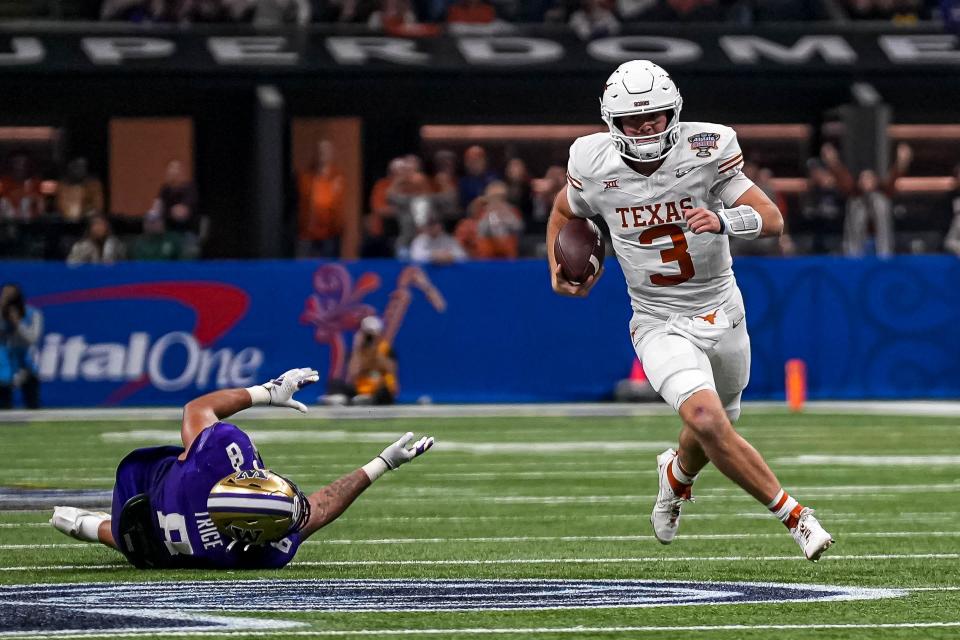 Texas Longhorns quarterback Quinn Ewers (3) evades a tackle by Washington edge Bralen Trice (8) during the Sugar Bowl College Football Playoff semifinals game at the Caesars Superdome on Monday, Jan. 1, 2024 in New Orleans, Louisiana.