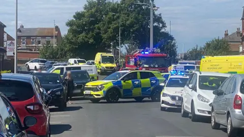 David Jack A police car blocks a busy road on Hart Street 