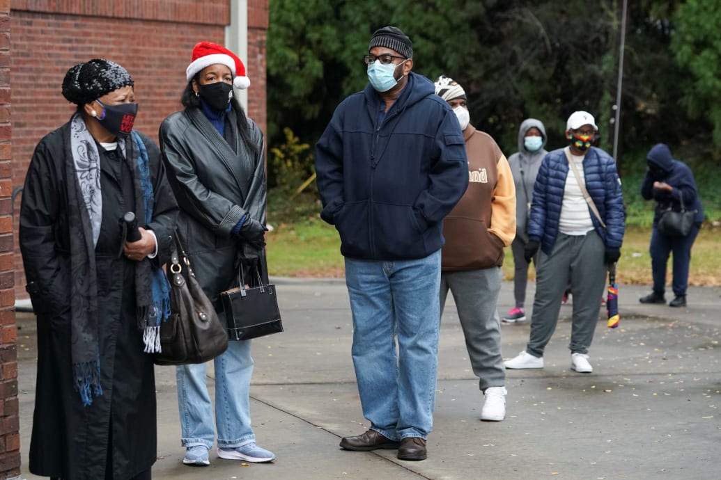 People in masks in a line