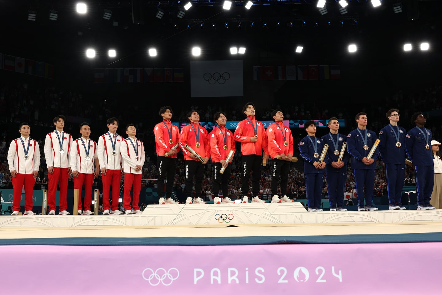 China (silver), Japan (gold), and the US (bronze) on the podium.