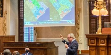 FILE - State Sen. Dick Harpootlian, D-Columbia, compares his proposed map of U.S. House districts drawn with 2020 U.S. Census data to a plan supported by Republicans on Jan. 20, 2022, in Columbia, S.C. A voting rights group sued South Carolina legislative leaders Monday, July 29, 2024, saying the maps they drew based on the 2020 Census lean too far toward Republicans. (AP Photo/Jeffrey Collins, File)