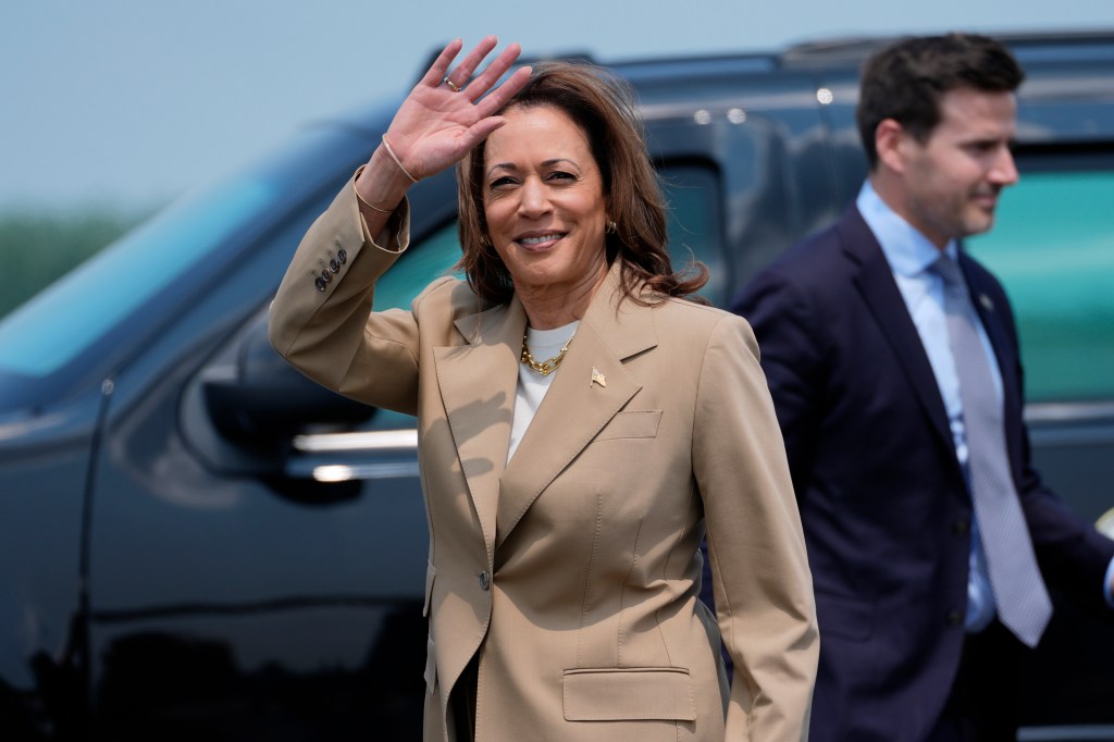 Vice President Kamala Harris waves as she arrives at Westfield-Barnes Regional Airport in Westfield, Mass