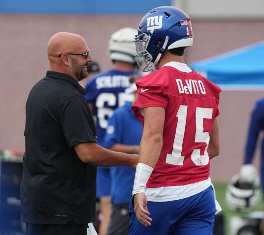 East Rutherford, NJ -- July 24, 2024 -- Head coach Brian Daboll and quarterback, Tommy DeVito during the first day of training camp for the 2024 New York Giants.